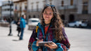 Colorful Young Woman with Notebook in Urban City Scene