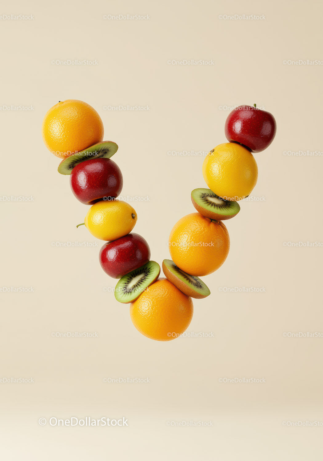 Colorful fresh fruits arranged in V shape on beige