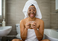 Young Woman Relaxing with Facial Mask and Hot Drink in Bathroom