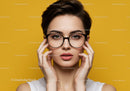 Chic Young Woman in Glasses with Bold Expression on Bright Yellow Background
