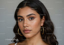Close-up of a Young Woman with Brown Eyes and Long Dark Hair in Stylish Makeup