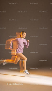 Athletic young woman sprinting with motion blur effect