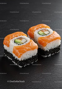 Fresh salmon sushi rolls with avocado and seaweed