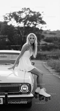 Young woman in dress and roller skates on vintage car