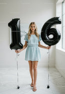 Teenage girl celebrating sixteenth birthday indoors