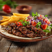 Grilled Lamb Kebabs with Fresh Salad and French Fries on Rustic Plate
