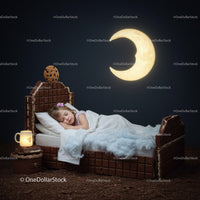 Sleeping child in chocolate bed under glowing moonlight