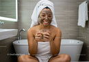 Happy Woman with Facial Mask Relaxing in Bathroom