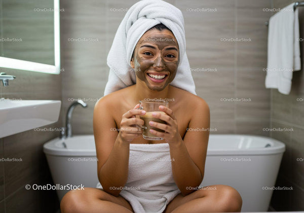 Happy Woman with Facial Mask Relaxing in Bathroom
