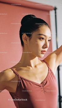 Focused young ballerina practicing graceful movements