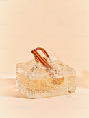 Cinnamon sticks frozen in transparent ice block