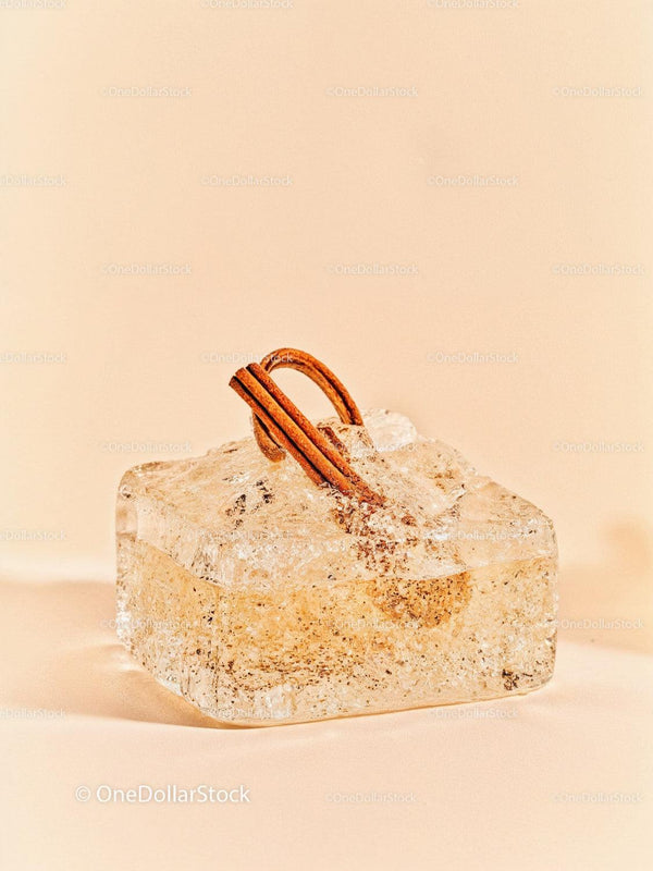 Cinnamon sticks frozen in transparent ice block
