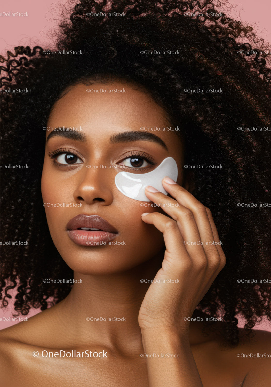 Black Woman with Curly Hair Applying Under Eye Patches for Skincare