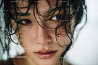 Close-up Portrait of a Woman with Wet Hair and Water Droplets