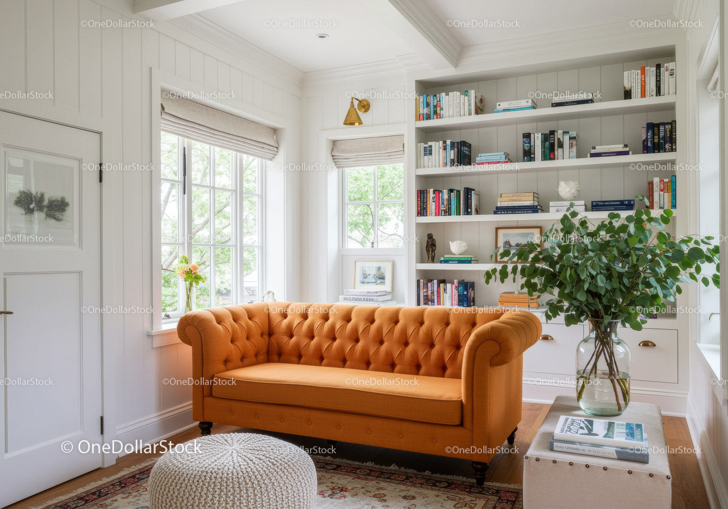 Bright living room with orange sofa and built-in bookshelves