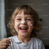 Happy child enjoying a playful yogurt moment