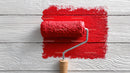 Red Paint and Painting Roller On White Wooden Surface