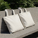 Two Blank Canvas Tote Bags Resting on Stone Bench