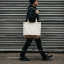Young man walking with canvas tote bag urban style