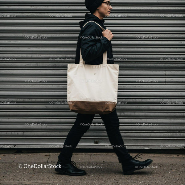 Young man walking with canvas tote bag urban style JPG Mockup Image