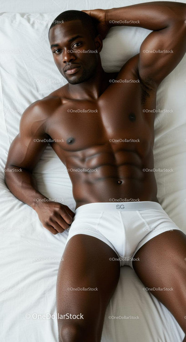 Relaxed muscular man lying on bed in white briefs