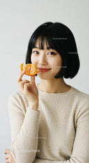 Woman with Tangerine Slice Showing Bright Cheerful Mood