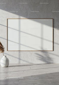 Minimalist blank frame on concrete wall with sunlight shadows