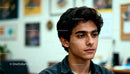 Young man in thoughtful mood indoors