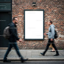 Blurred pedestrians walking past blank brick wall poster