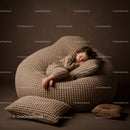 Peaceful toddler sleeping on beige textured beanbag
