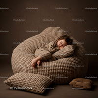 Peaceful toddler sleeping on beige textured beanbag