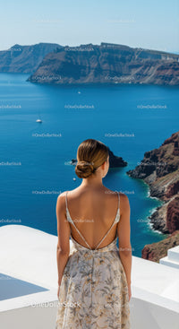 Woman Enjoying Scenic Ocean View from Cliffside Terrace
