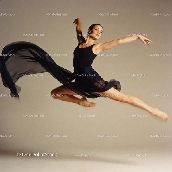 Graceful ballerina leaping with flowing black skirt