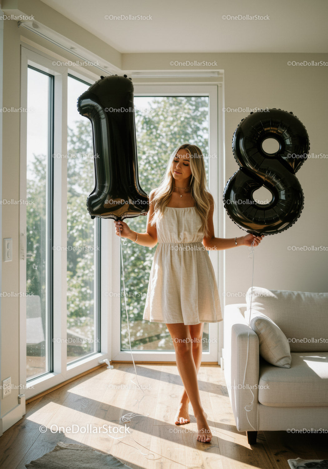 Young woman celebrating 18th birthday with balloons