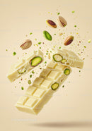 White chocolate bar with pistachios in mid-air explosion