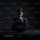 Thoughtful Woman at Laptop in Dark Modern Workspace