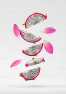Floating dragon fruit slices with pink flower petals