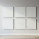 Minimalist blank white frames on bright gallery wall