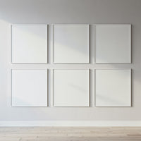 Minimalist blank white frames on bright gallery wall