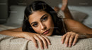 Close-up Portrait of a Young Woman with Dark Hair Relaxing on Carpet
