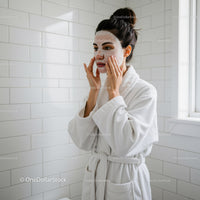Woman Applying Facial Mask in Spa Setting for Healthy Skin
