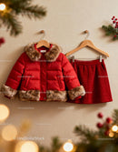 Red winter jacket and skirt hanging on wall hooks