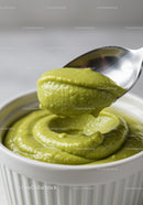 Creamy green avocado dip in white ceramic bowl