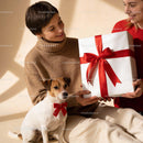 Joyful Gift Exchange with Dog Wearing Red Bow Tie
