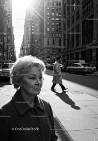 Elderly Woman Walking on City Street in Black and White Urban Scene