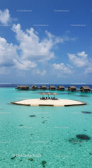 Overwater Bungalows on a Tropical Island with Clear Turquoise Water