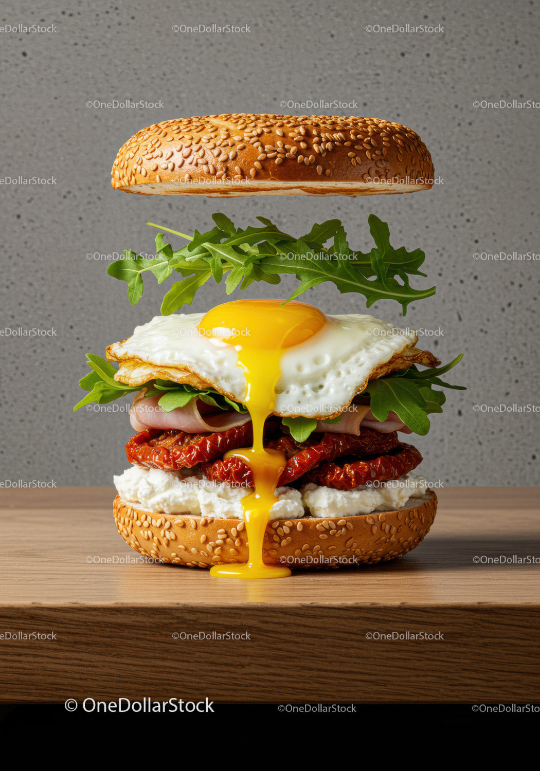 Gourmet sesame bagel sandwich with runny egg yolk