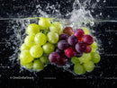Close-Up of Fresh Green and Purple Grapes Splashing Water