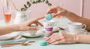 Elegant Tea Party with Colorful Macarons and Fine China Cups