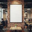 Cozy cafe interior with blank poster on brick wall